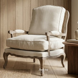 Premium accent armchair with natural linen cushions and woven rattan back by Thomas & Hurley