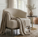 Honor Occasional Tub Chair in linen by Thomas & Hurley displayed in a light-filled room with floor-to-ceiling wainscoting.