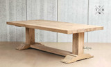 The Charlested Oak Dining Table under soft, ambient lighting, emphasizing the warm, natural tones of the oak