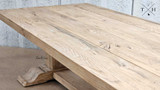 A close-up image showcasing the handcrafted details of the Charlested Oak Dining Table, emphasizing its quality craftsmanship.