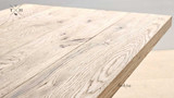 Close-up image of the Charlested Oak Dining Table surface, highlighting the intricate texture of the oak wood