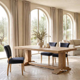 Luxury oak dining table by Thomas and Hurley with architectural pedestal legs, natural timber finish, and elegant contemporary appeal.