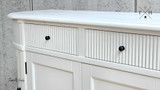 Detailed close-up of the intricate grooved detailing on the drawers of the Louis Petite Buffet.