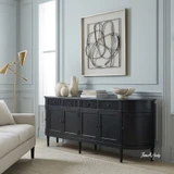 Angled view of the Louis curved sideboard in black in a modern living room