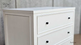 Close-up of the top drawer knob detailing the elegant hardware.