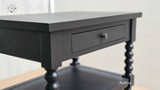 Angled view from the top corner highlighting the spindle and drawer design.