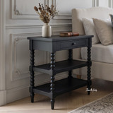 Transitional style black bedside table with open lower shelving by Thomas and Hurley.
