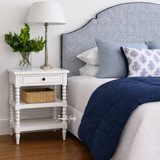 A styled angled view of the Montclair Side Table in White by Thomas and Hurley.