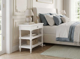 Thomas and Hurley Montclair white nightstand in an elegant bedroom with soft green and blue linens.