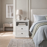 White wooden bedside table with cross molding details by Thomas and Hurley.