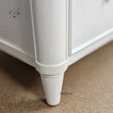 Close-up of the bedside table’s legs, featuring unique design for a timeless look.