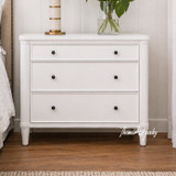 Front view of a white three drawer side table, perfectly complementing modern or Hamptons bedroom or living room spaces.