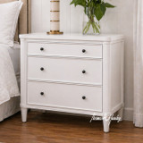 A white three drawer side table showcasing storage and clean simple design.