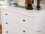 A close up view of a three drawer bedroom chest in white, which would perfectly complement either Hamptons or contemporary interiors.