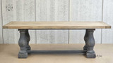 Side view of the Parkhouse Double Pedestal Dining Table showcasing its distressed grey base and oak top.