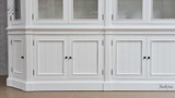 Close-up of the lower storage compartment of the Stonefield Double Display Cabinet Wall Unit with Angled Sides, emphasising the ample space and usability.