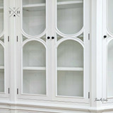 Close-up of the cabinet doors, revealing the detailed arch designs and high-quality craftsmanship.