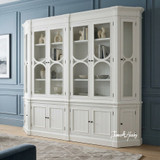 The Stonefield Double Display Cabinet Wall Unit with Angled Sides with a styled view, showcasing its hidden display base cabinet and top display cabinet.