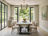 The Parkhouse Double Pedestal Dining Table creates a striking centrepiece in this contemporary dining room, pairing a hand-finished oak tabletop with a distressed grey double pedestal base. Styled with upholstered dining chairs and framed by architectural arched windows, it brings timeless elegance to modern Australian homes.