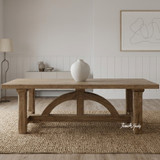 The oak Trailbridge dining table showcasing curved solid base