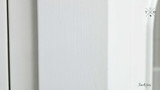 Close-Up of White Paint Finish - A detailed view of the Stonefield Wall Unit’s white paint-stroke patina, showcasing the hand-finished and subtly distressed surface that adds a layer of texture and depth to its classic design.