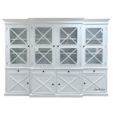 Front on view of the Somerset 4 Door Display Wall Unit, showcasing its elegant craftsmanship, distinctive cross design, and versatile use as both a display unit and a bookshelf in any coastal-inspired home.