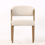 Front view of the Stanton Dining Chair in fabric with natural timber legs, showcasing its contemporary design and refined Hamptons style aesthetic.