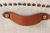 Detailed close up of the Stratford Dining Chair back with signature brass studding and top grain leather pull handle