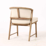 Three quarter rear view of the Windsor Dining Chair displaying the curved timber back rail and frame construction, combining architectural form with designer craftsmanship