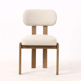 Front view of the Stuttgart Dining Chair in richly textured weave with natural timber legs, showcasing its contemporary design, curved backrest, and refined modern Hamptons-inspired silhouette by Thomas & Hurley.