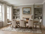 A luxury timber dining table with extension leaves and architectural trestle legs