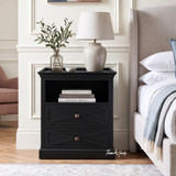 Elegant black storage nightstand featuring geometric drawer fronts and an open cubby.