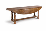 Angled view of the Churchill Barley Twist Oval Drop Leaf Extending Table by Thomas and Hurley with leaves down, presenting a streamlined silhouette ideal for sophisticated transitional spaces and curated interior styling.