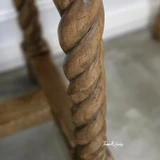 Close up detailed view of barley twist leg showcasing timeless craftsmanship and rich oak grain and patina.