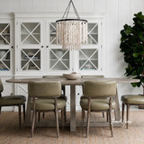 Ovalis 280cm Dining Table in brushed oak styled in a spacious dining room with leather chairs