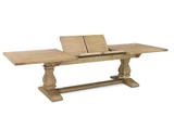 The Sandringham Double Extension Dining Table by Thomas & Hurley shown from a front angled perspective highlighting the sculptural pedestal base and contemporary Hamptons design, open with leaf extensions showing.
