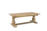 The Sandringham double extension dining table photographed from a front angled view in its closed position, showing its generous proportions and sculptural base.