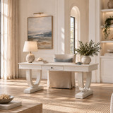Luxury white home office desk with sculptural curved legs in a warm minimalist interior