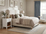 White Lando 1 Drawer bedside table styled with ceramic lamps and soft neutral bedding in a contemporary Hamptons bedroom.