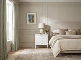 White Lando 3 Drawer bedside table styled with a sculptural table lamp and vase beside a bed, framed by sheer linen curtains and large windows in a light-filled bedroom.