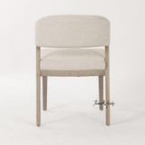 High-end linen dining chair with architectural silhouette by Thomas & Hurley in neutral upholstery with natural brushed oak timber legs