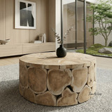 Maki Round Teak Log Trunk Coffee Table by Thomas and Hurley in a warm minimalist living room
