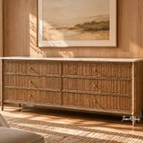 Premium wide dresser with warm natural finish and fine vertical reeding, and marble top, beneath a landscape artwork