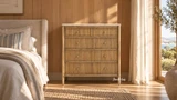 Designer bedroom furniture featuring Brookstone five drawer marble top chest