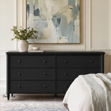 Brynmore black chest of drawers with six framed drawers and tapered legs in a styled contemporary space