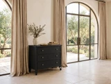 Premium black bedroom chest with three storage drawers and metal knobs in a styled room with natural light and linen drapes