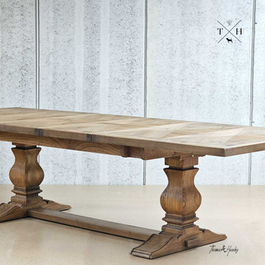 View of the Darcy Oak Table's pedestal table while fully extended, showcasing its support and elegance.
