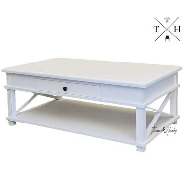Side view of the coffee table, emphasising the unique cross-beam leg detailing and high-quality construction