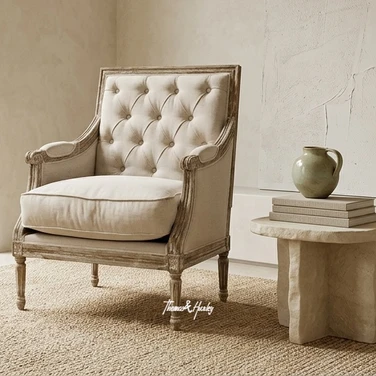 Premium lounge chair in tufted cream upholstery styled in a contemporary classic living room