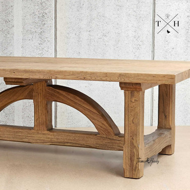 Zoomed-in view of the unique 'bridge-style' legs, a hallmark of the Trailbridge Table’s design.